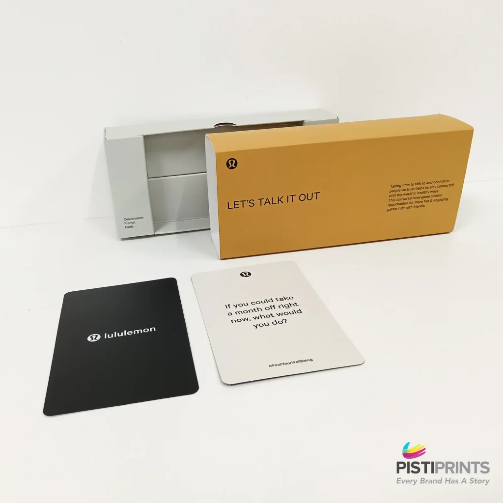 Custom printed conversation card set with sleek packaging and sample cards displayed on a white surface — example of personalized packaging design for business branding in Singapore.