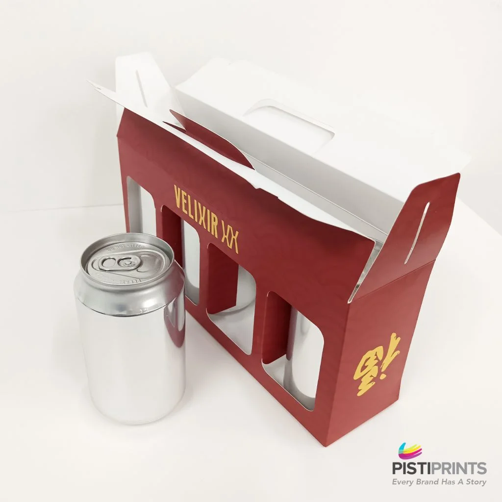 Eco-friendly cardboard packaging with cans and a carry handle.
