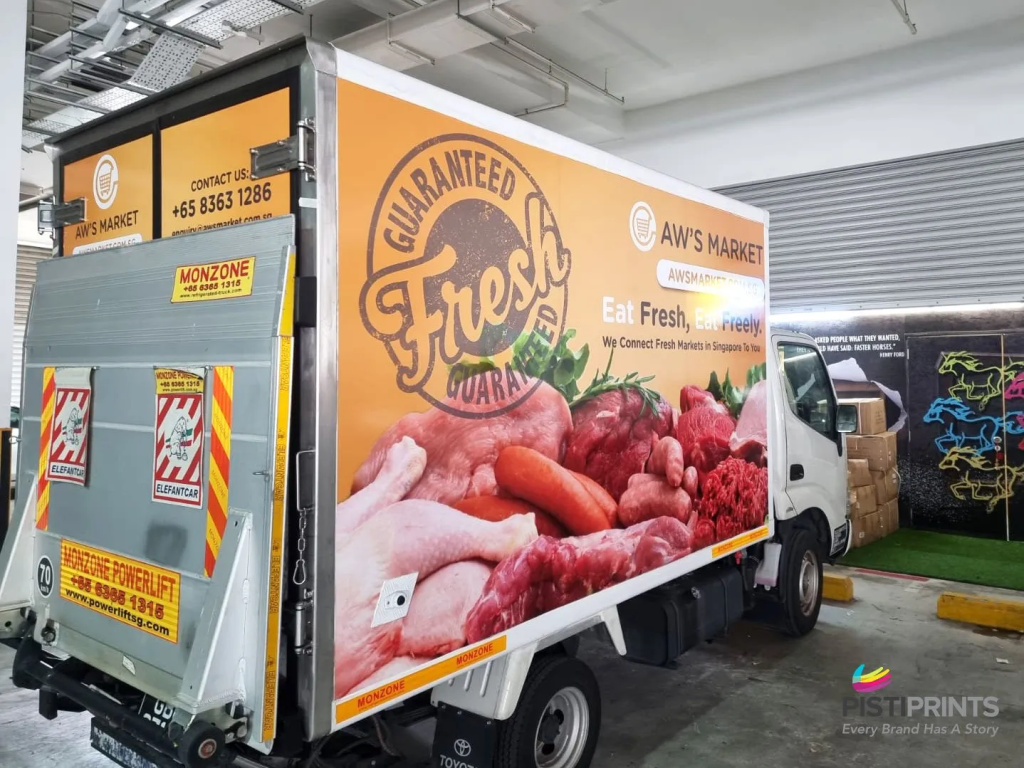 Delivery truck wrapped with branded vehicle stickers showcasing a fresh food market advertisement, demonstrating mobile advertising in action.