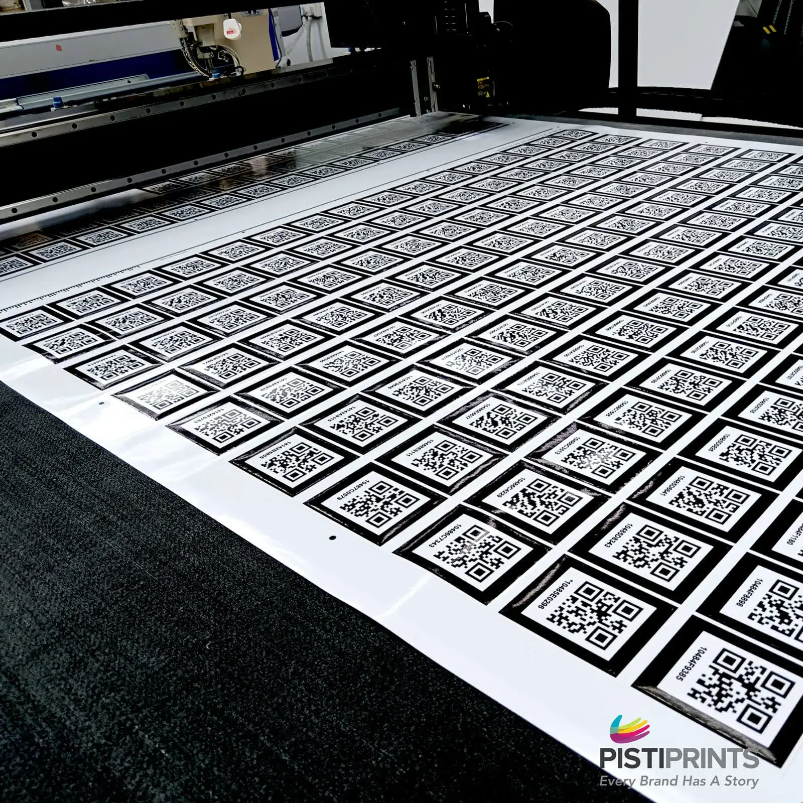A large sheet of QR code stickers being produced on a professional printer, illustrating the efficiency and flexibility of short-run printing in Singapore.